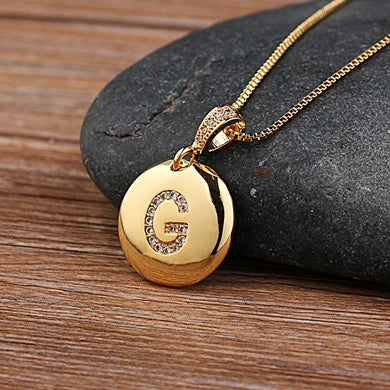 Copper initial letter necklace featuring charm pendants with CZ stones, designed for women and girls by 𝕄𝕔 𝕋𝕙𝕖 𝔹𝕝𝕒𝕔𝕜 𝔻𝕚�