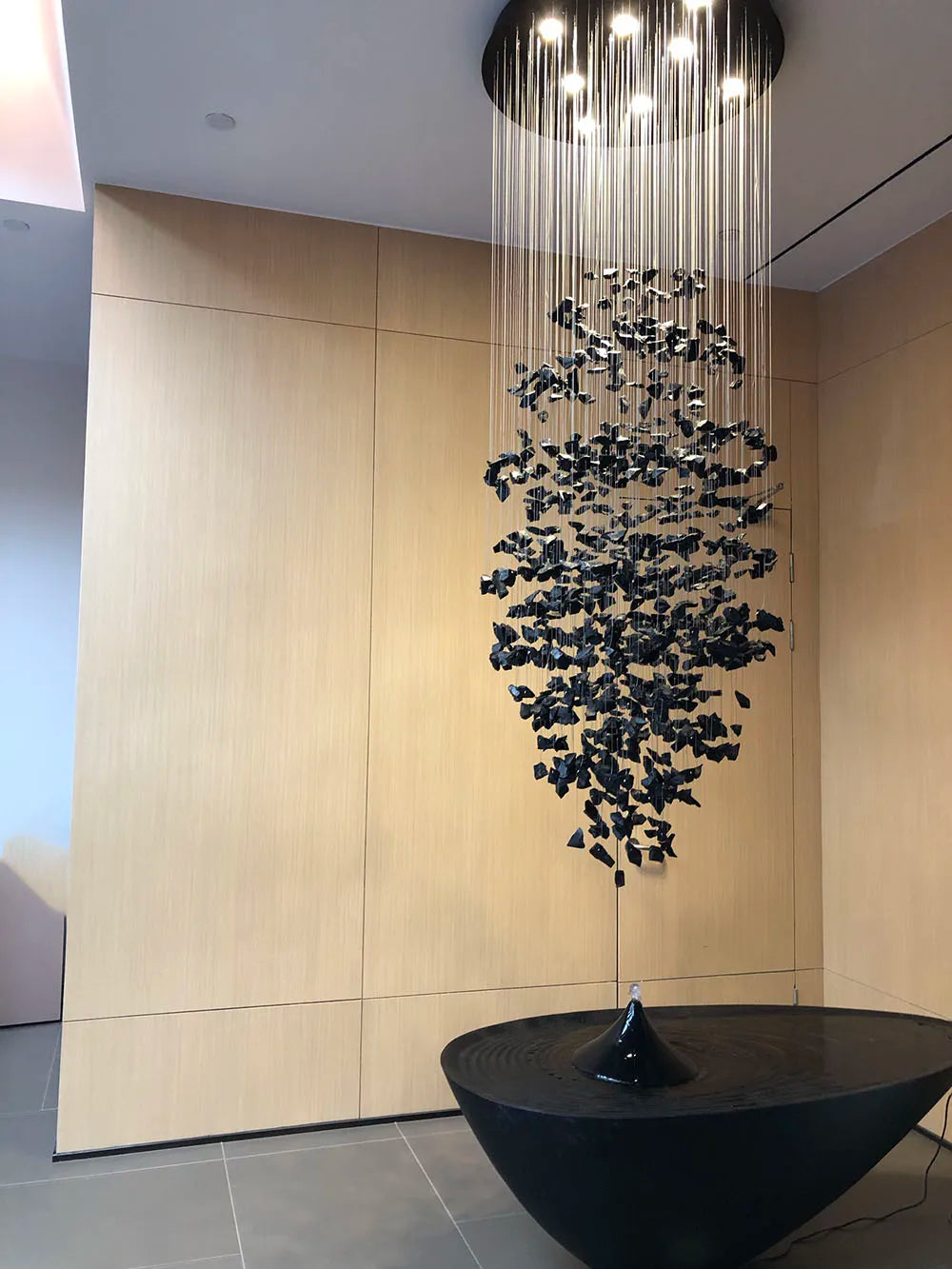 Modern stone crystal LED chandelier by MC THE BLACK DIAMOND, large luxury staircase and living room light fixture with elegant design.
