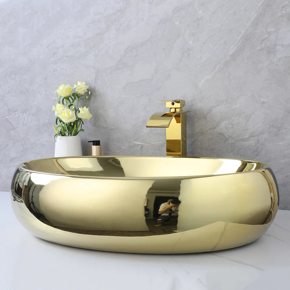 KEMAIDI luxury gold ceramic 23-inch oval bathroom vessel sink with gold waterfall faucet and mixer, above counter design.
