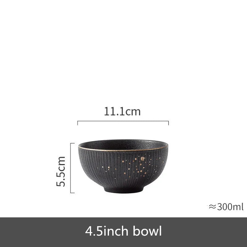 Set of black porcelain dinner plates with gilt rim, featuring food and cutlery, from MC The Black Diamonds kitchenware collection.