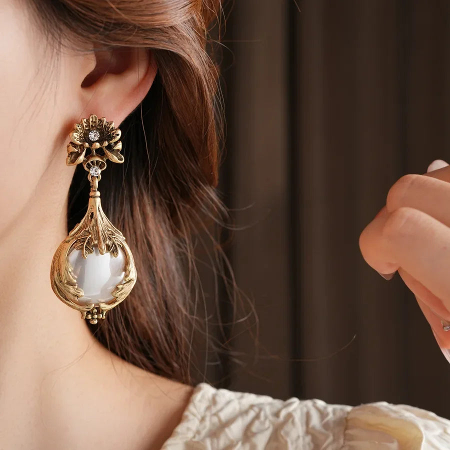 Vintage light luxury jewelry set for women featuring rhinestone inlaid flower pendant, pearl earrings, and high-end retro necklace.