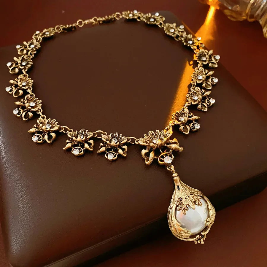 Vintage light luxury jewelry set with rhinestone flower pendant, pearl earrings, and high-end necklace for women.