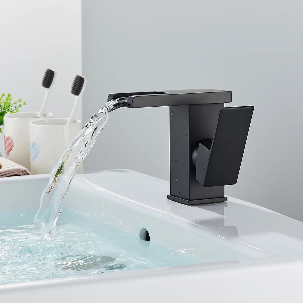 Black brass waterfall bathroom sink faucet with single handle, deck-mounted hot and cold water mixer, by 𝕄𝕔 𝕋𝕙𝕖 𝔹𝕝𝕒𝕔𝕜 𝔻𝕚�