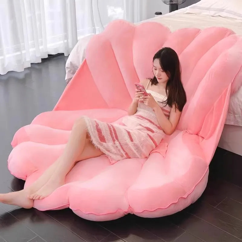 Large clam shell plush cushion from MC The Black Diamond, shaped like a giant seashell sofa pillow, perfect for kid beds.