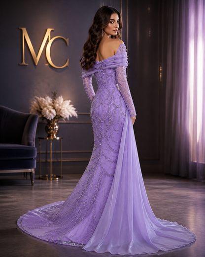 Elegant one-shoulder evening dress in luxurious tulle by MC THE BLACK DIAMOND, featuring a flowing silhouette and intricate detailing.