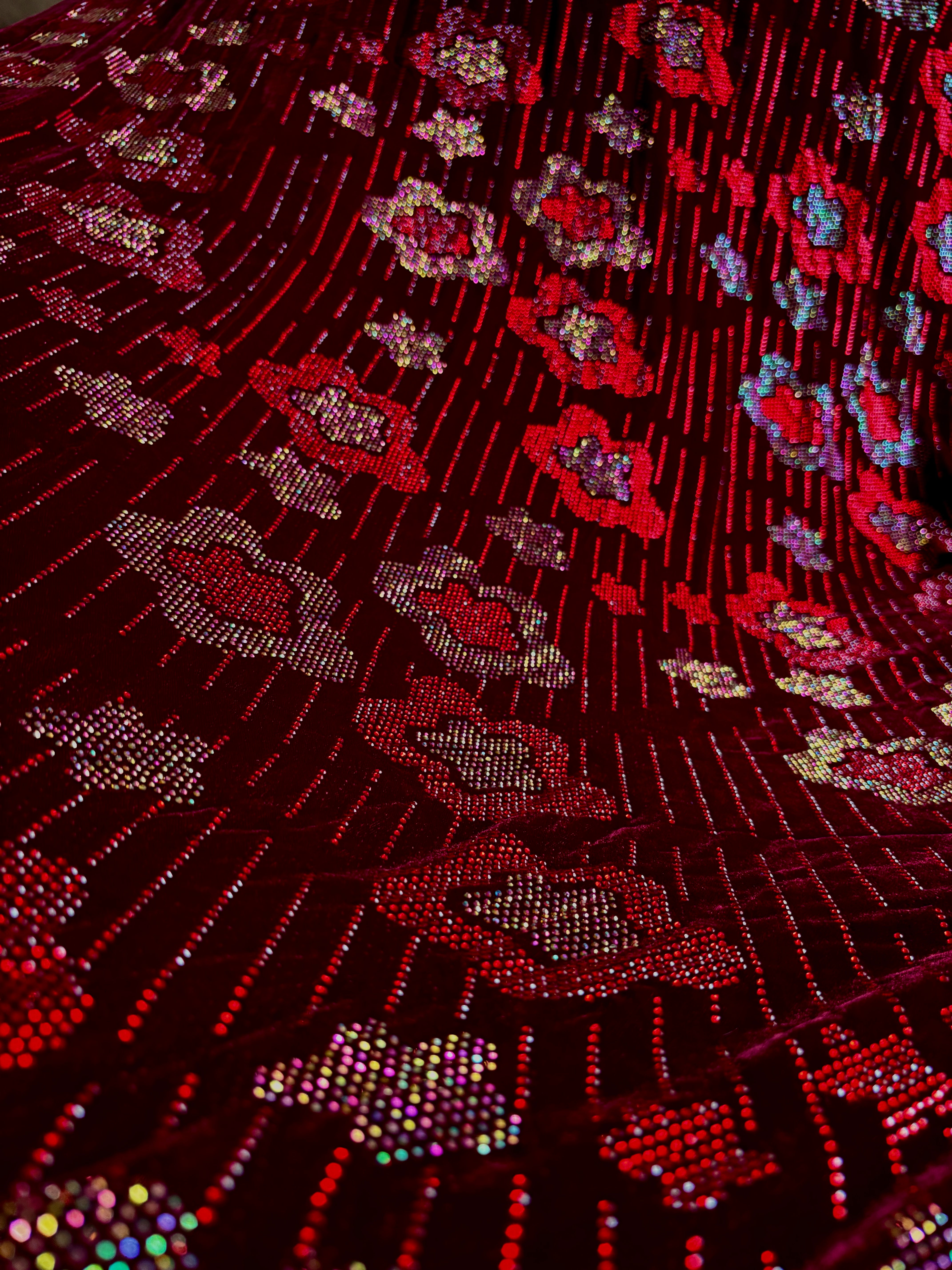 Red velvet floral fabric suit by Stretch Velvet, featuring intricate floral patterns on soft, luxurious velvet material.