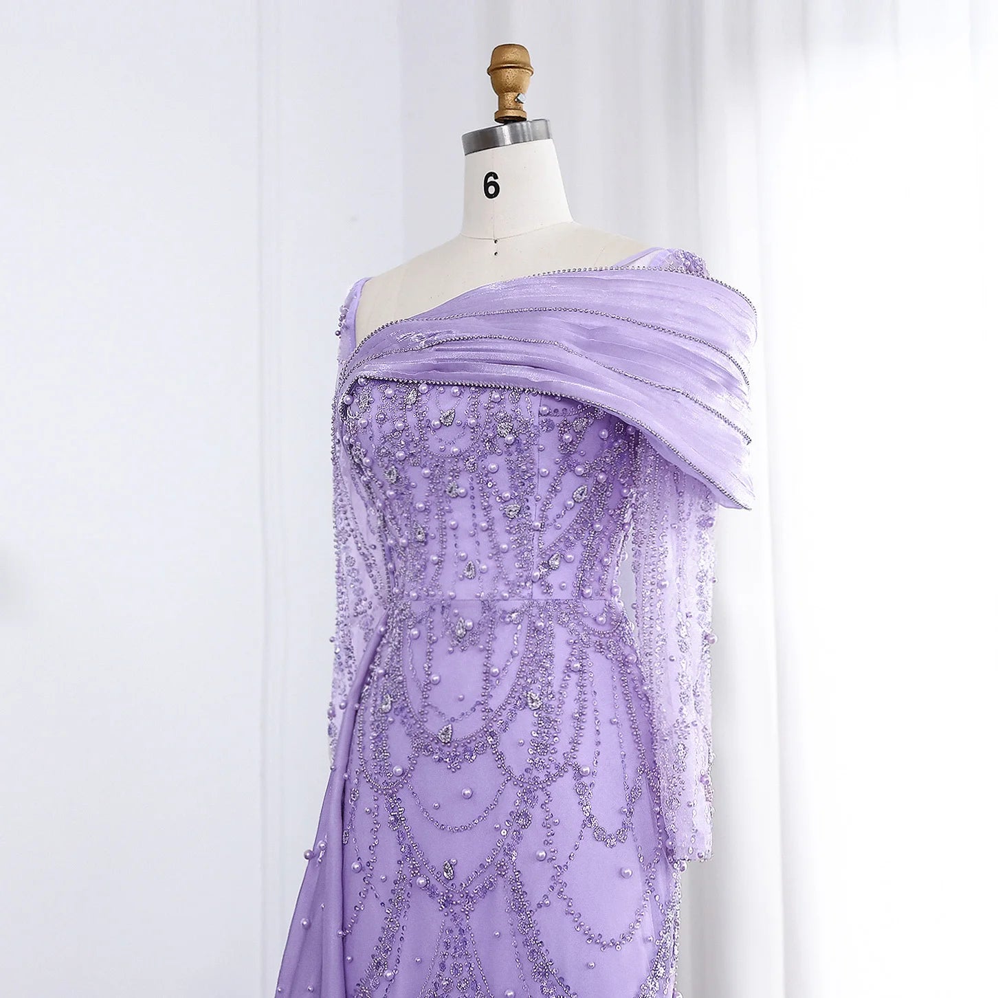 Elegant one-shoulder evening dress in luxurious tulle by MC THE BLACK DIAMOND, showcasing a flowing silhouette and sophisticated design.