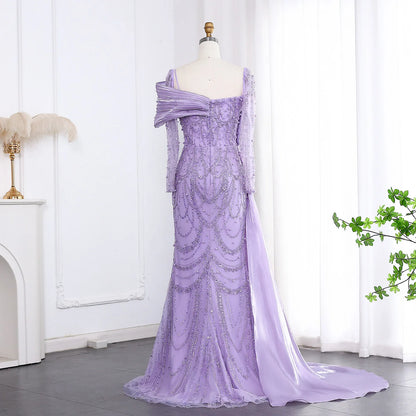 Elegant one-shoulder evening dress in luxurious tulle by MC THE BLACK DIAMOND, showcasing a flowing silhouette and intricate detailing.