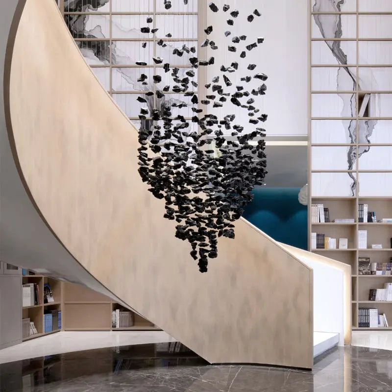 Large modern stone crystal LED chandelier by MC THE BLACK DIAMOND, hanging in a staircase or living room setting with luxurious style.
