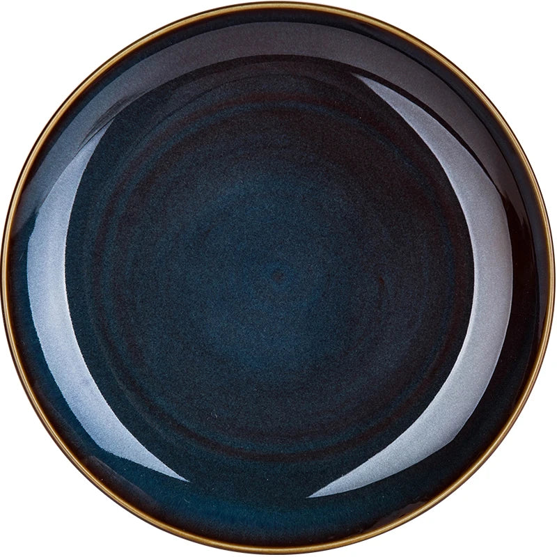 Deep blue ceramic dinnerware set by MC The Black Diamonds, featuring elegant European-style kitchen tableware with plates and bowls.