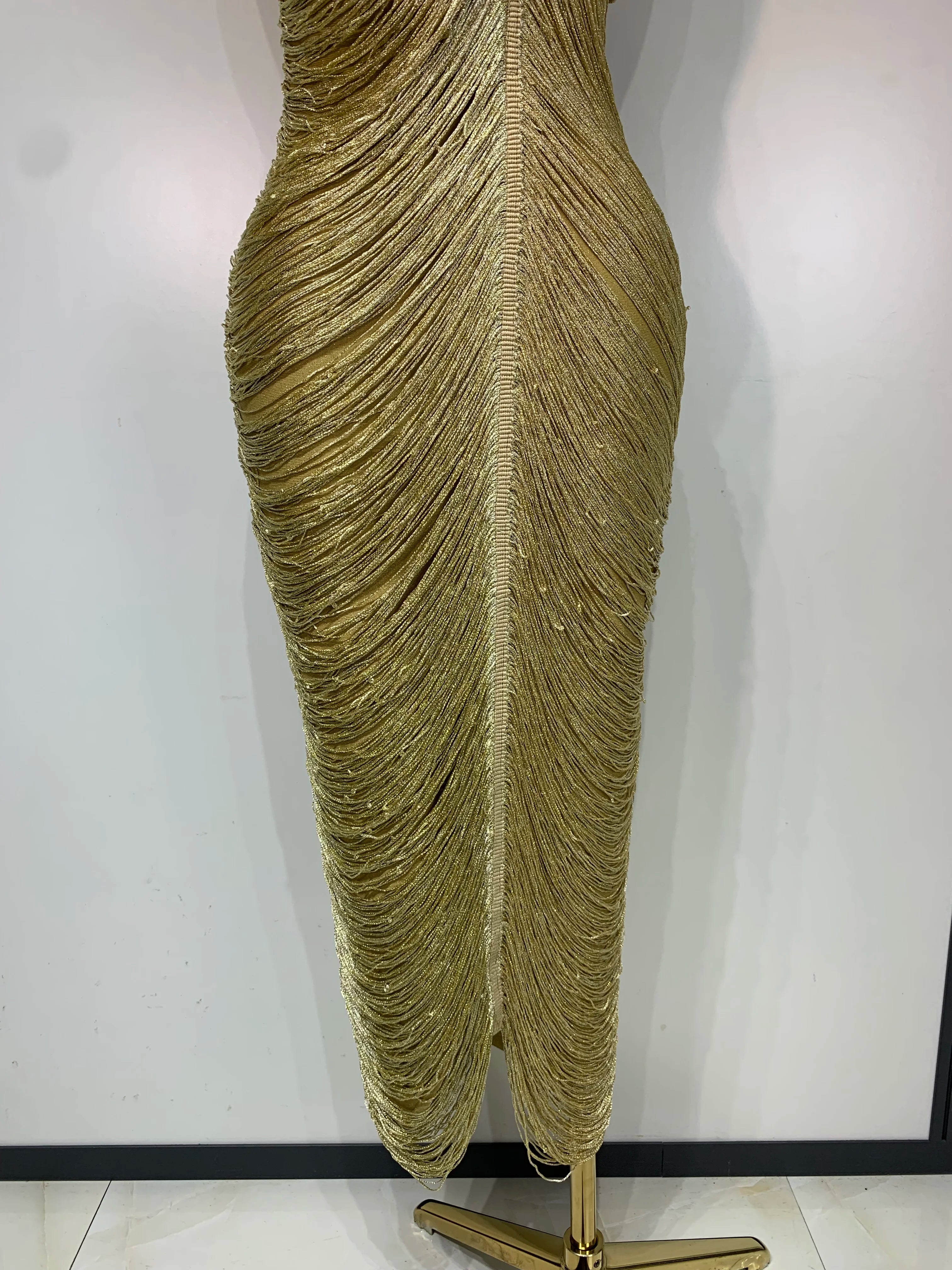 MC Women backless gold bandage bodycon dress with tassel details, stylish and form-fitting for elegant occasions.