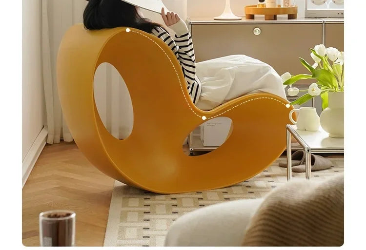 Modern MC THE BLACK DIAMOND rocking armchair made of durable PE plastic with a sleek, curved design for comfortable lounging.