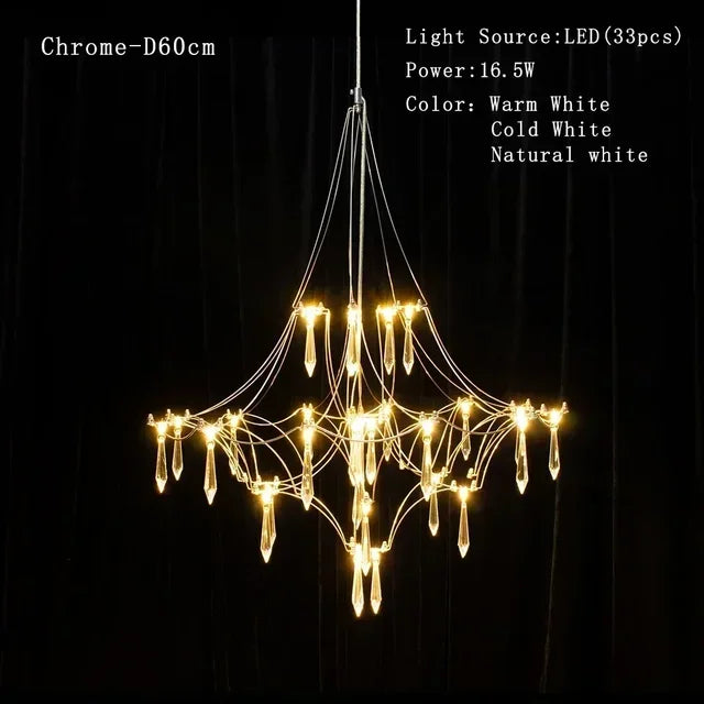Modern chrome-plated luxury crystal chandelier by MC THE BLACK DIAMOND, featuring multiple hanging crystal prisms in a living room setting.