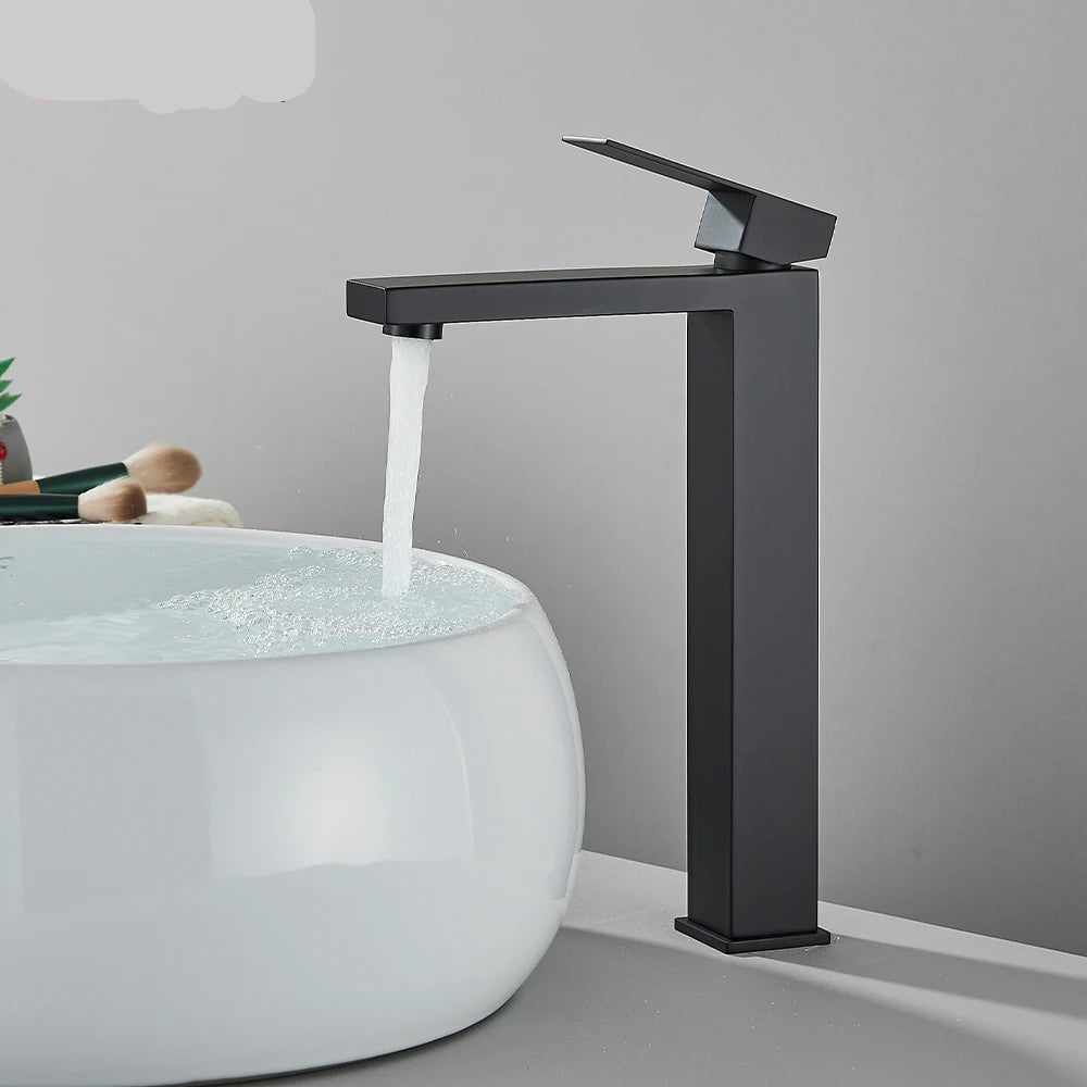 Matte black stainless steel bathroom sink faucet with cold and hot water mixer, deck-mounted waterfall tap from 𝕄𝕔 𝕋𝕙𝕖 𝔹𝕝𝕒𝕔𝕜 𝔻𝕚