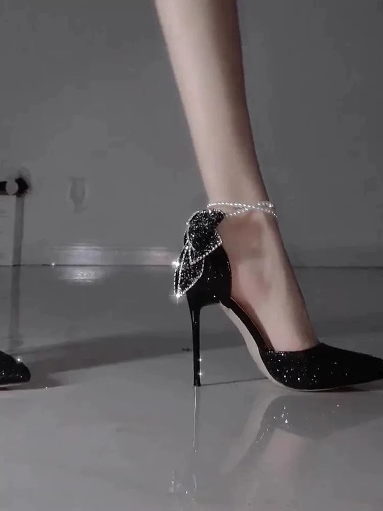 Elegant women's high heels with a pointy toe, sequin bow detail, pearl accents, and a shallow mouth design by Mohammad Collection.