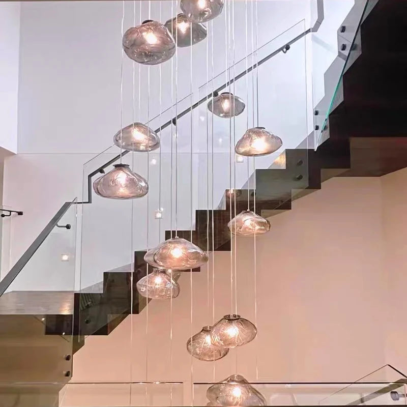 Nordic-style MC THE BLACK DIAMOND pendant light hanging in living room or bedroom, modern stair chandelier decor.