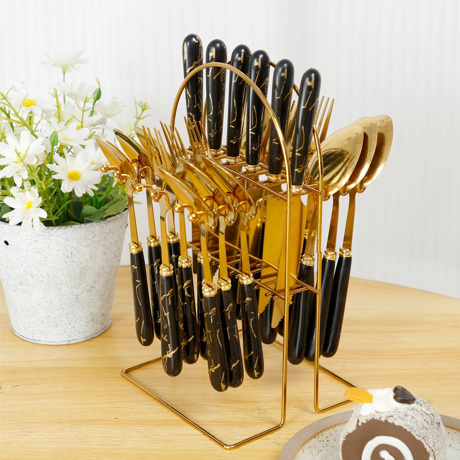 Stainless steel flatware set with holder, including 24 pieces of cutlery from MC THE BLACK DIAMOND, displayed on a table.