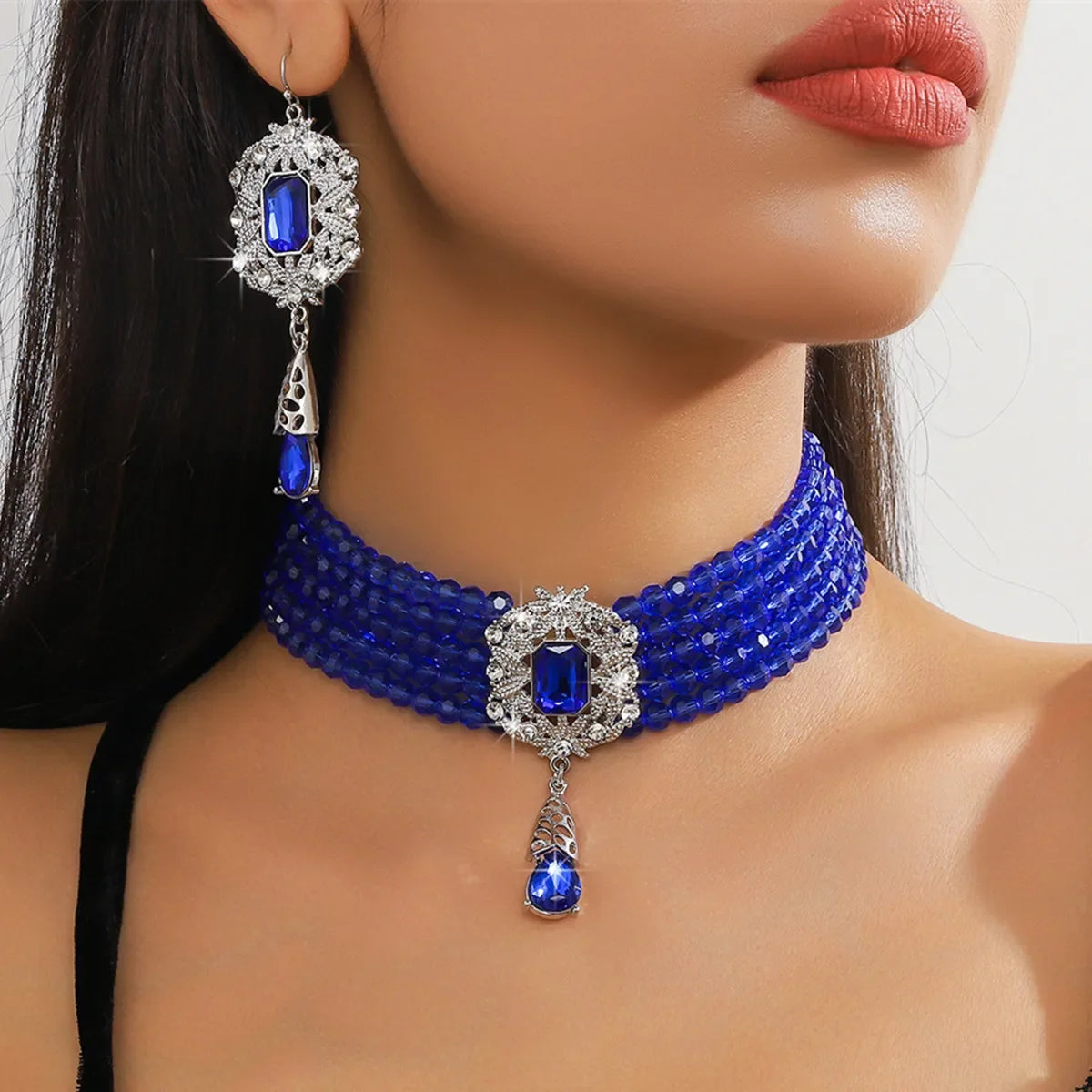 Vintage MC THE BLACK DIAMOND multilayer green, red, blue crystal necklace with geometric design and matching hollow alloy earrings.
