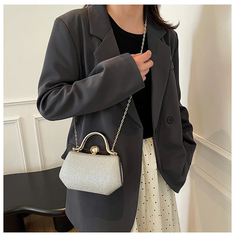 Black MC The Diamonds hand bag with a solid color, chain strap, and simple crossbody design for versatile evening wear.