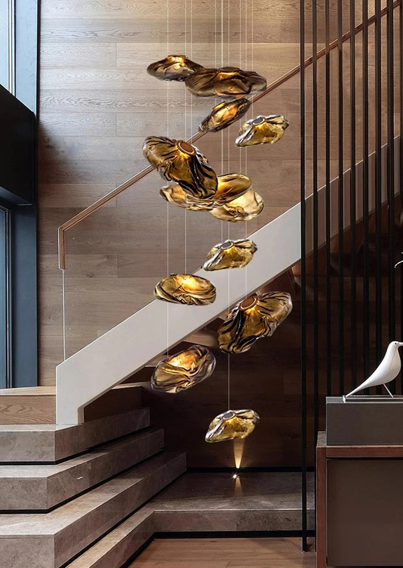 Nordic style pendant light by MC THE BLACK DIAMOND hanging in a living room or bedroom, modern stair chandelier decor