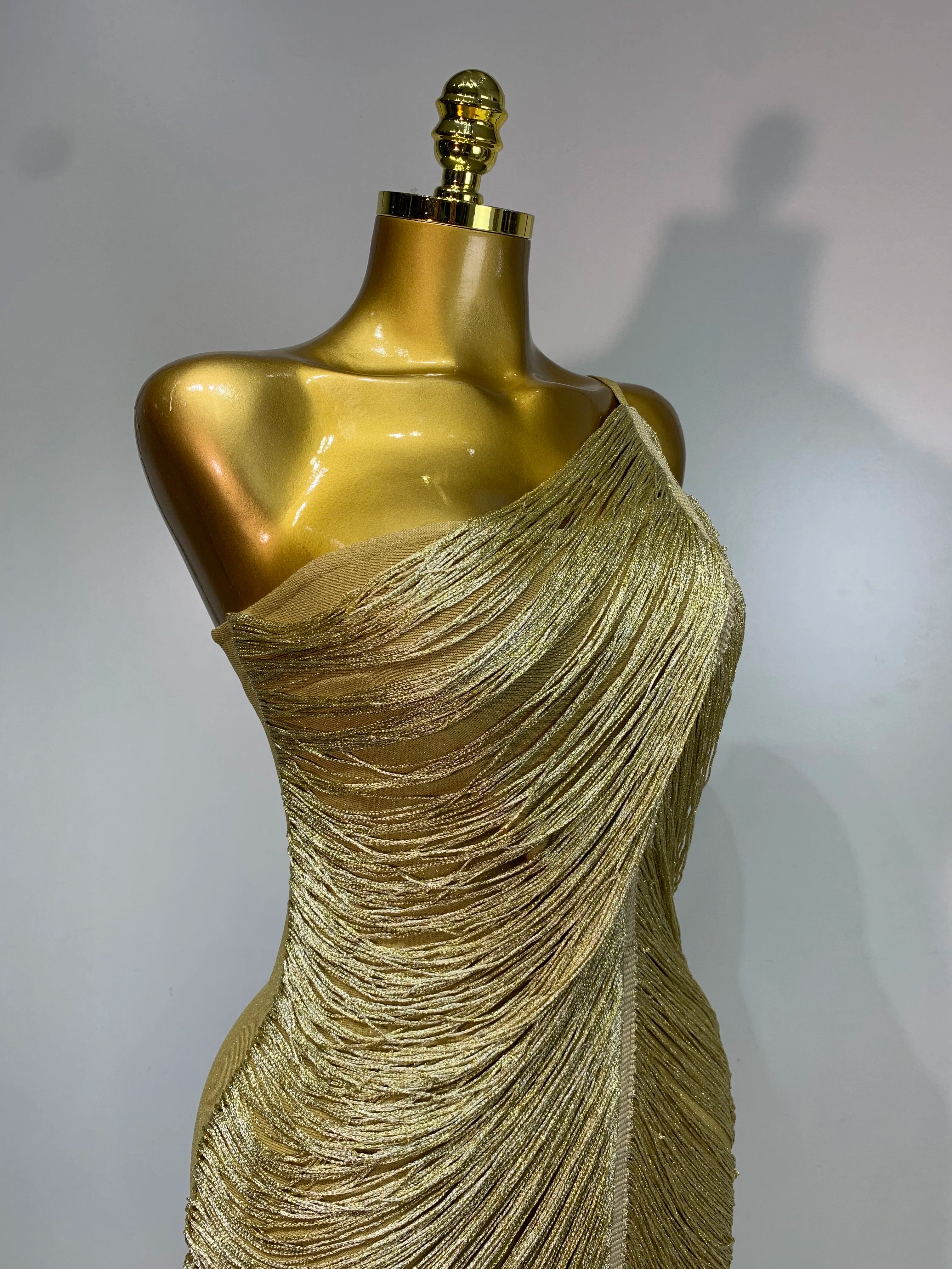 MC women’s backless gold tassel bodycon bandage dress by MC THE BLACK DIAMOND, featuring a fitted silhouette and elegant backless design.