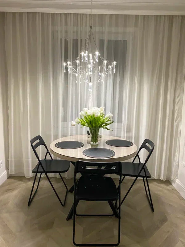 Modern chrome-plated luxury crystal chandelier by MC THE BLACK DIAMOND, featuring multiple hanging crystal accents for living room lighting.