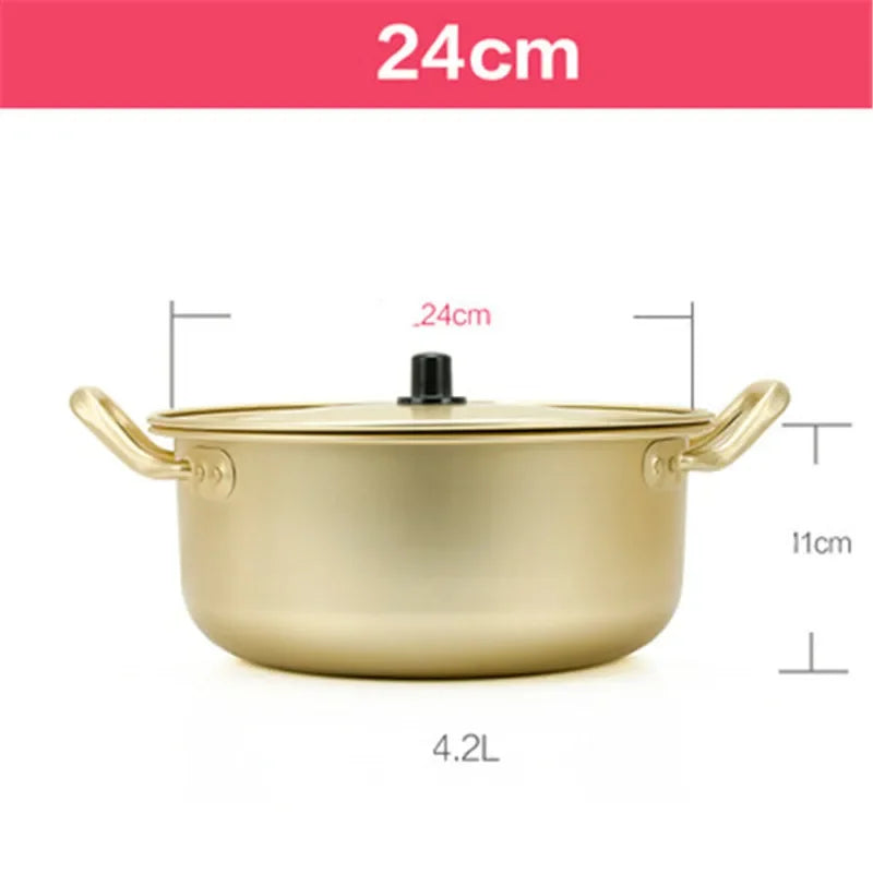 Korean style ramen noodles in a gold aluminum hot pot with eggs, ideal for soup cooking, by MC THE BLACK DIAMOND in a kitchen setting.