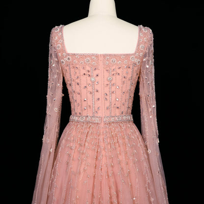 Elegant pink Dubai evening dress by MC THE BLACK DIAMOND, featuring luxurious fabric and intricate design details.