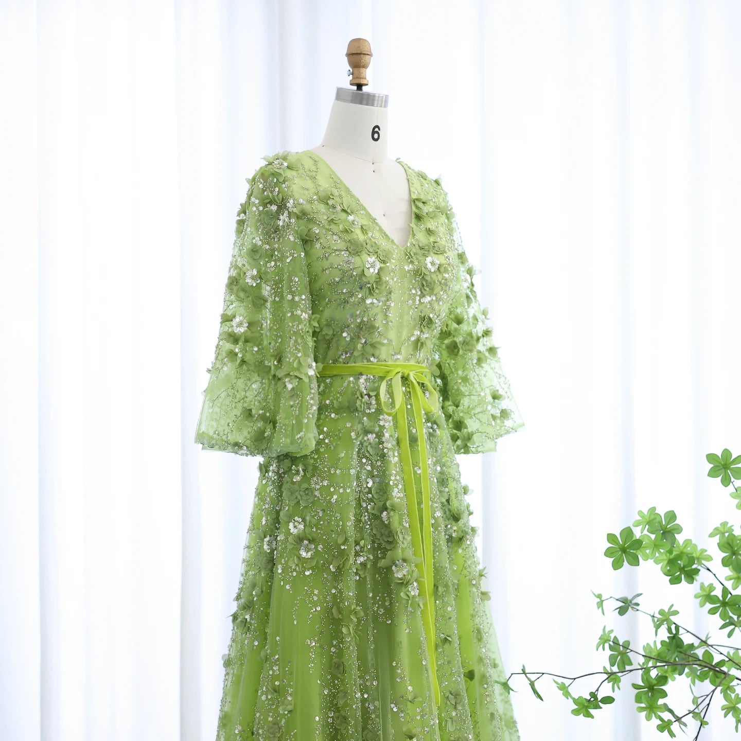 Green evening dress by MC THE BLACK DIAMOND featuring a V-neck, 3D embroidered flowers, perfect for wedding or party occasions.