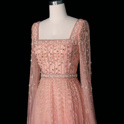 Elegant pink Dubai evening dress by MC THE BLACK DIAMOND featuring a flowing fabric and intricate design, perfect for formal occasions.
