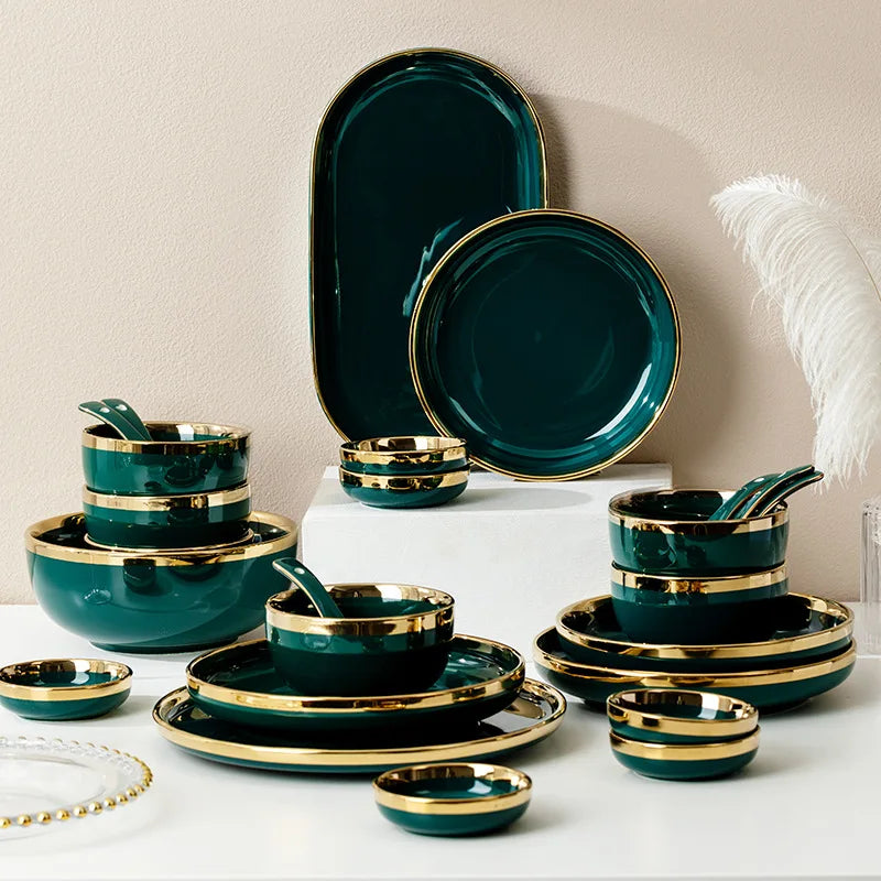 Dark green ceramic cutlery bowls set with gold-plated accents, including rice bowls and porcelain plates for kitchen use.