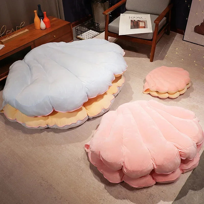 Large seashell-shaped plush pillow by MC THE BLACK DIAMOND, ideal as a giant clamshell cushion for kid beds or sofa decor.