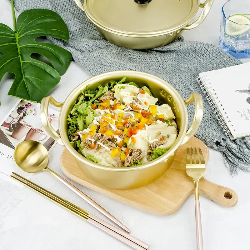 Korean style ramen noodles in a gold aluminum hot pot with an egg, showcasing traditional cookware by MC THE BLACK DIAMOND