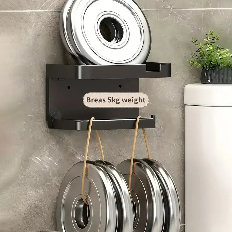 Plastic bathroom toilet paper holder and kitchen towel rack by MC THE BLACK DIAMOND, mounted on wall with space for seasoning bottles and phone.